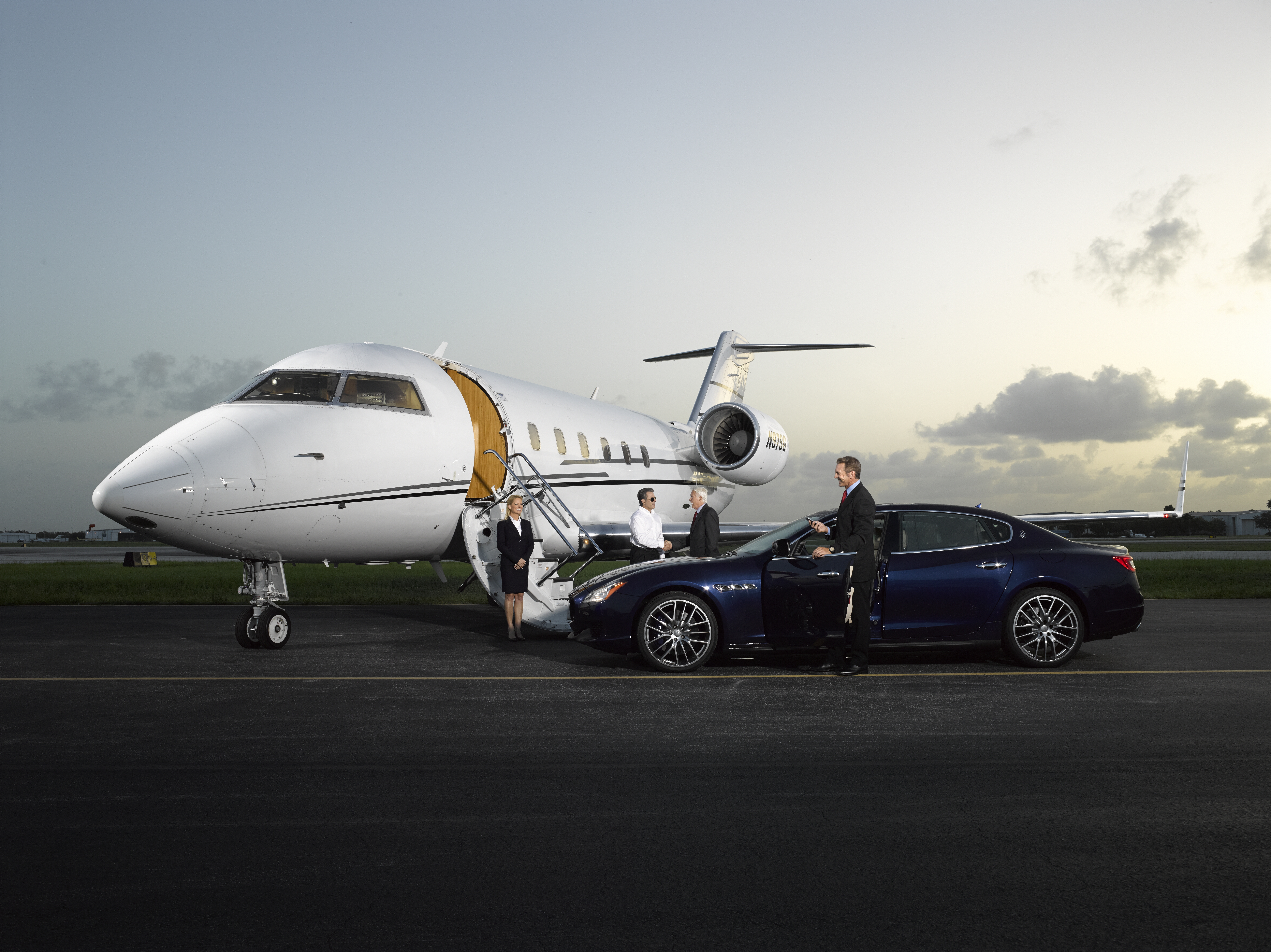 Mechanic working on jet on tarmac under Part 135 management